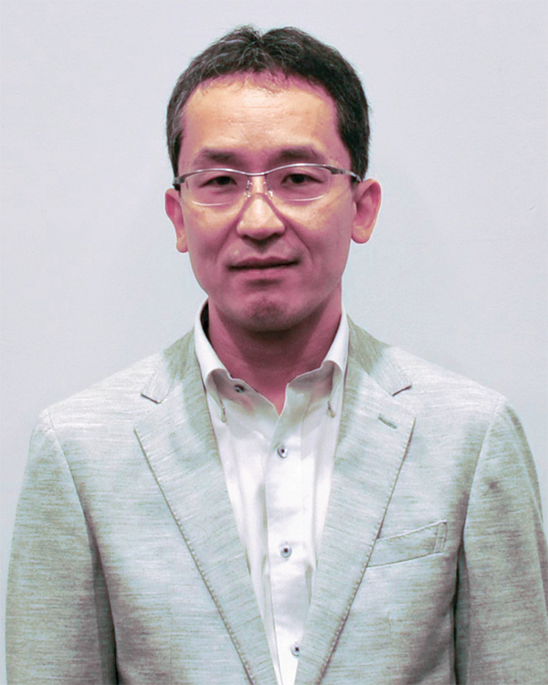 A person wearing a light gray suit jacket over a white dress shirt.