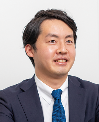 Portrait photograph of a man in a business suit and blue tie, representing Tokio Marine & Nichido, facing slightly to the side.
