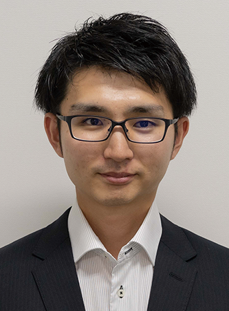 Business portrait of a man wearing glasses and a suit, facing the camera with a neutral background.