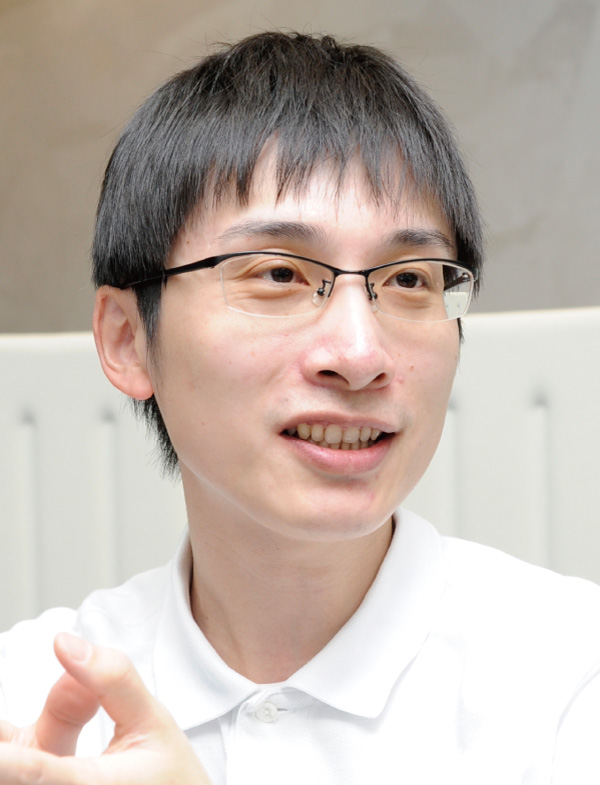 A man wearing glasses and a white shirt is talking.