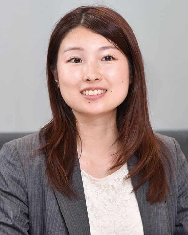Portrait of a Mitsubishi Soko case study speaker, featuring a woman in professional attire with long brown hair, smiling against a neutral background.