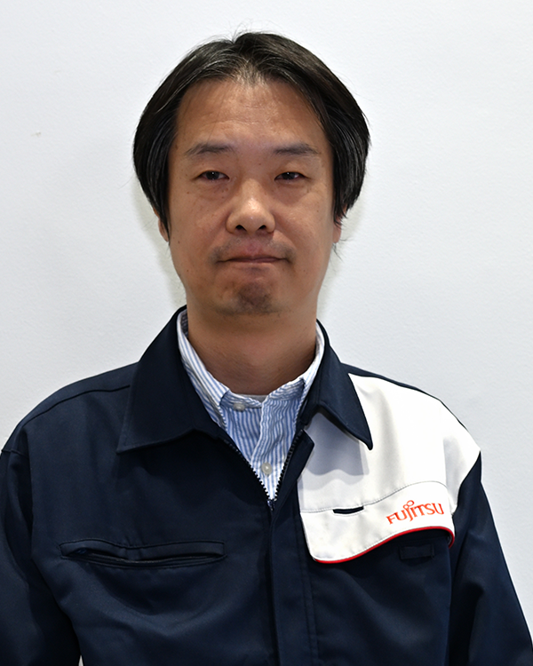Portrait of a Fujitsu General employee wearing a company uniform, standing against a plain background.