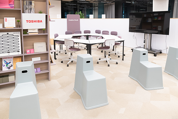 Modern office interior of Toshiba Infrastructure Systems in Japan, featuring collaborative workspaces, contemporary furniture, and a clean, organized environment.