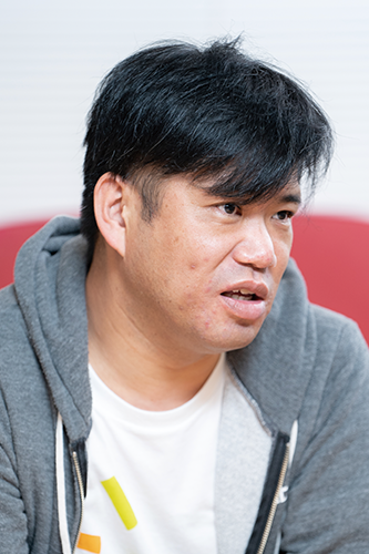 Portrait of a person in a casual grey hoodie, featured in a Nulab case study.