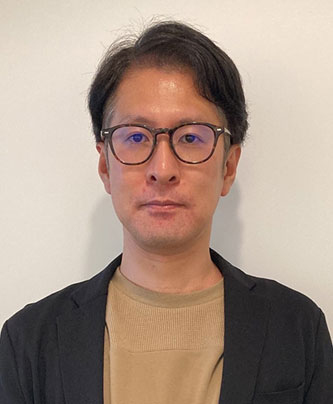 Portrait photo of a man wearing glasses and a blazer, to accompany a JPX case study speaker profile.