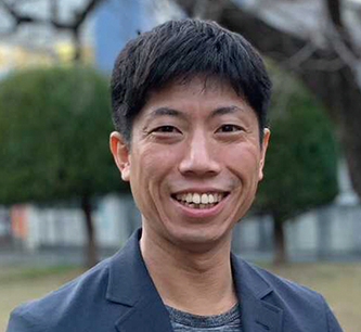 A smiling man is pictured outdoors in a casual setting, suitable for use in a case study or testimonial context.