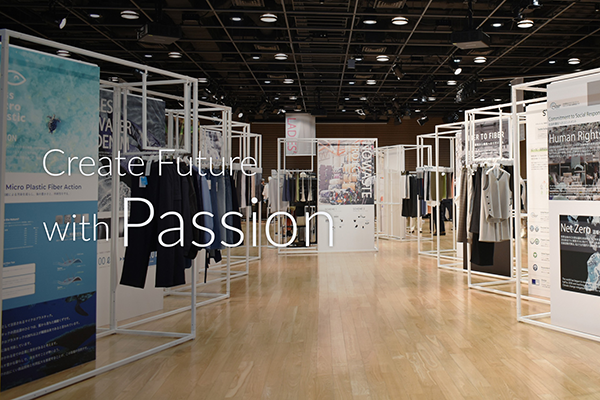 Photo of the Takihyo Exhibition 2023, showcasing clothing and informative displays in a modern exhibition hall with the text 'Create Future with Passion' visible.