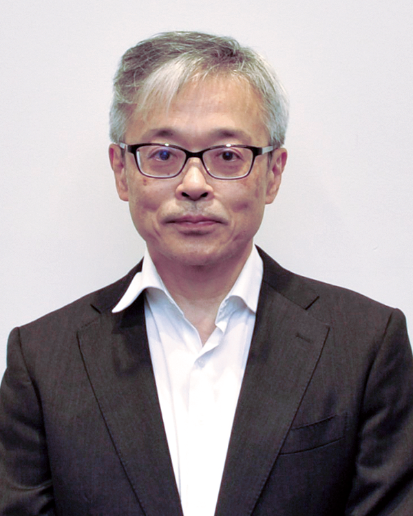Portrait of a business professional with glasses and gray hair in a white shirt and dark suit, posed against a plain background. Used for a case study speaker feature in the Japan region.