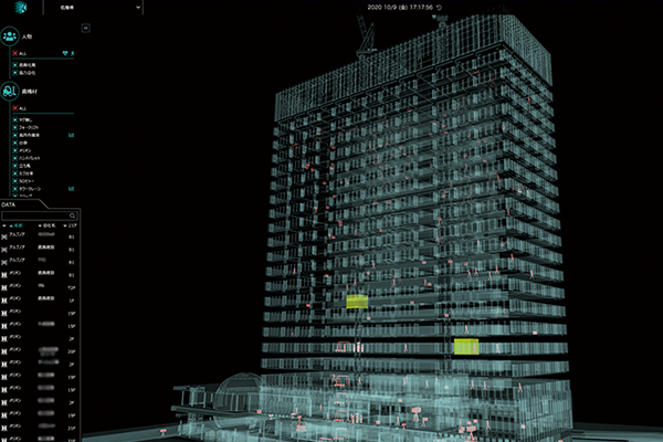 A digital building visualization from the Kajima Construction AWS case study, showing a detailed 3D model of a high-rise structure with various data layers and metrics displayed on a dark background.
