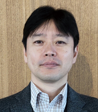 A portrait of a businessman standing in front of a wood background, as used in the Konica Minolta solution case study.
