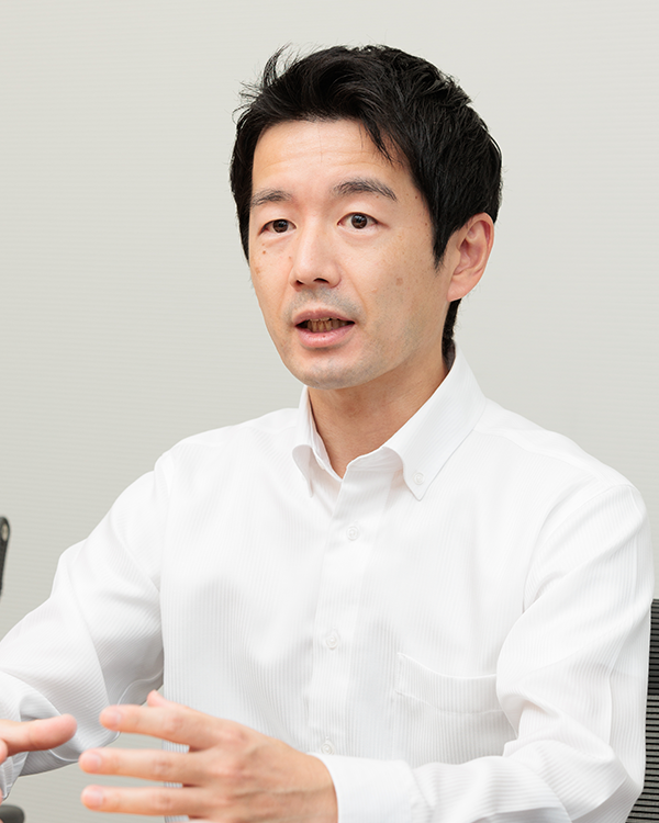 A person wearing a white button-up shirt, gesturing with their hands.