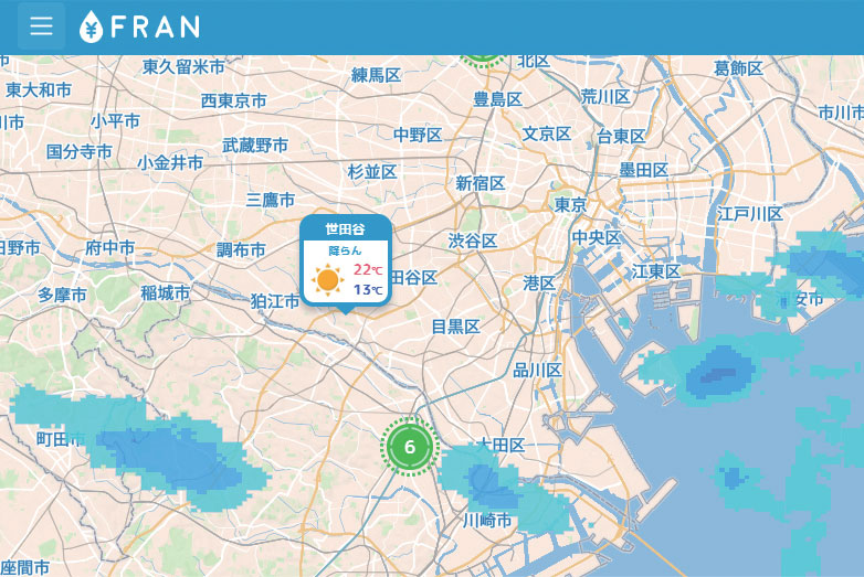Map of Tokyo area showing weather information for Setagaya with a sunny icon and temperatures of 22°C and 13°C, alongside blue shaded areas indicating rainfall.