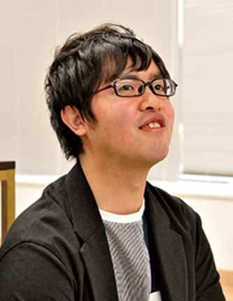 A person with glasses indoors, wearing a black jacket, featured in the Kokuyo case study.