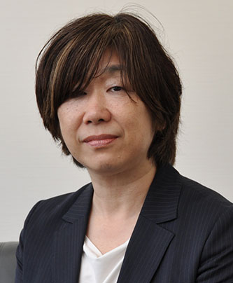 Portrait of a Nichirei case study speaker, Watanabe Fumiko, wearing a dark blazer and white top, seated against a neutral background.