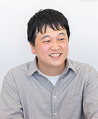 Portrait of a smiling man in a light checkered shirt, featured as a speaker for the Basefood case study.