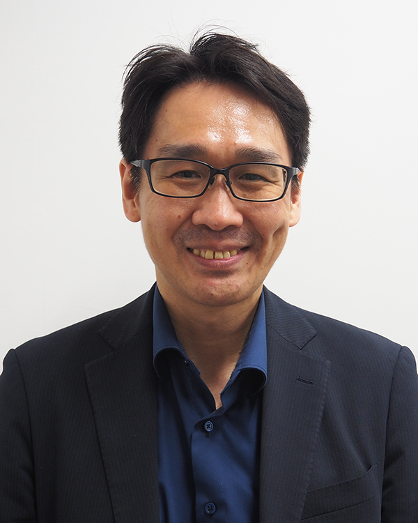 Portrait photograph of a man in business attire wearing glasses, featured in the Isehan case study for AWS Japan.