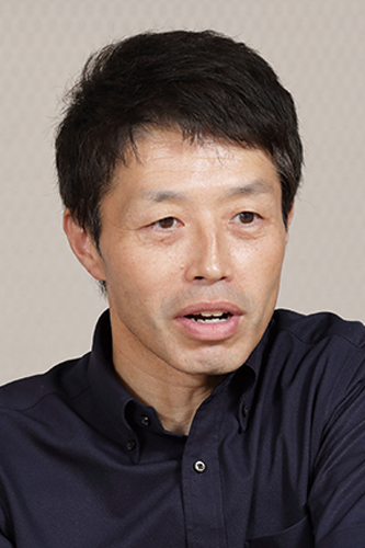 Portrait photograph of a man in a dark shirt, identified as Mr. Matsuura from Sojirushi, used for a solution case study.