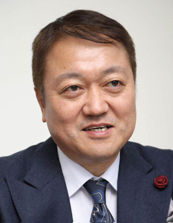 A professional portrait of a man wearing a suit and tie, suitable for business or corporate use.