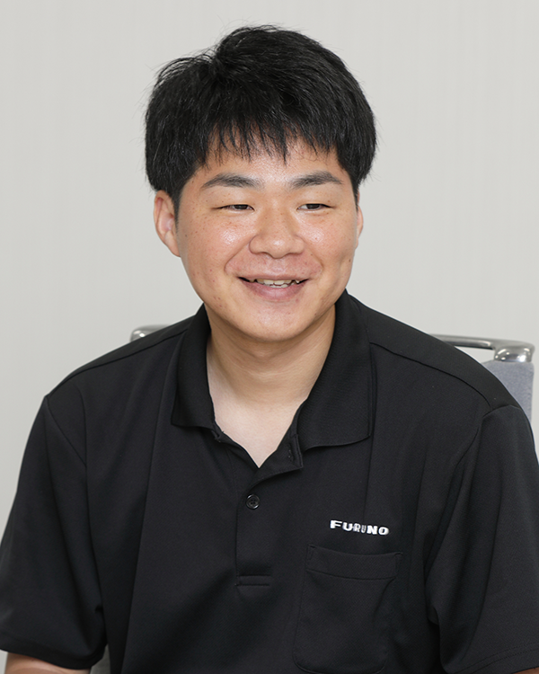 A man wearing a black Furuno shirt, seated and smiling, featured as a speaker in the Furuno case study.