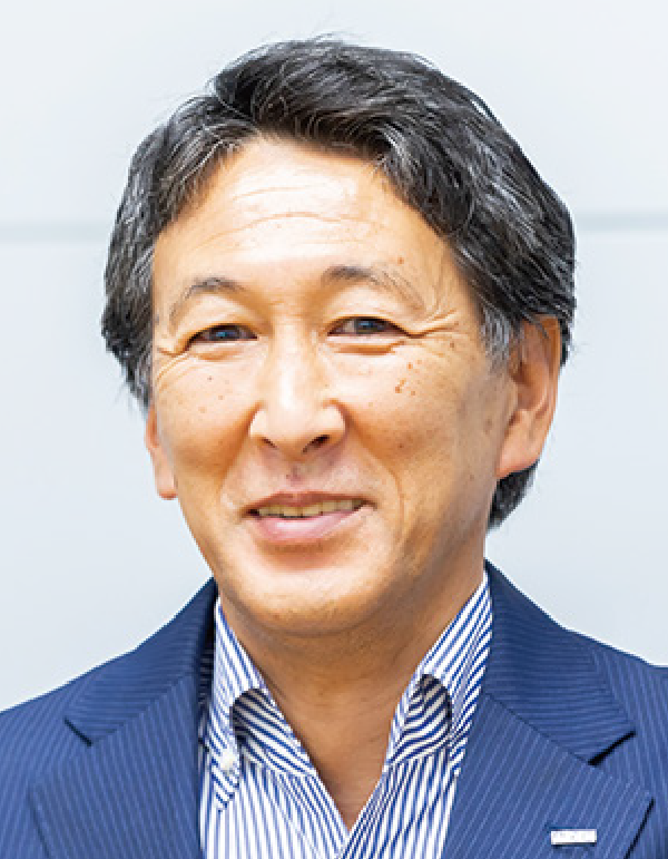 Headshot of a smiling middle-aged man wearing a business suit.