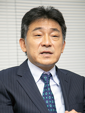 Portrait of Mr. Kinoshita from Ecostyle, wearing a suit and tie, used in an AWS Japan solution case study.