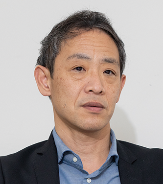 Portrait of a man in a business suit against a plain background