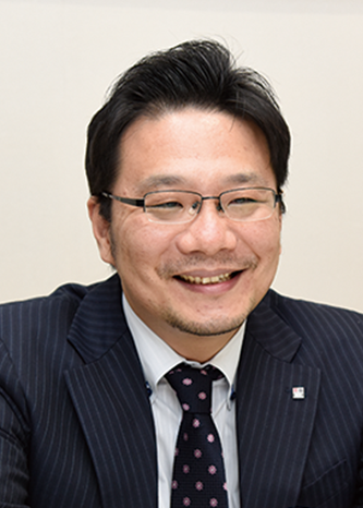 Portrait of a business executive in a suit and glasses, featured in the Toppan Forms case study.