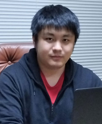 Portrait photo of a man sitting at a desk with a laptop, used for the Ikuyo case study speaker profile.
