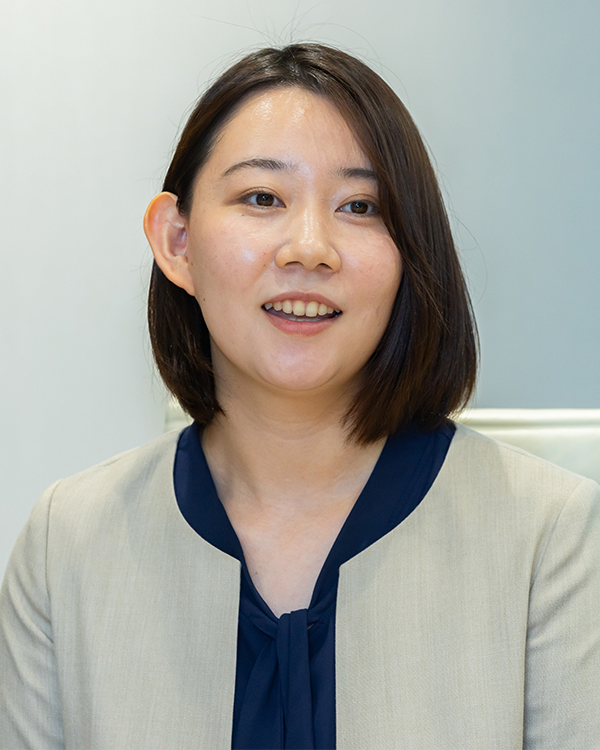 Portrait photo of a businesswoman in a light blazer and navy blouse, used for Panasonic case study interview content on AWS Japan website.
