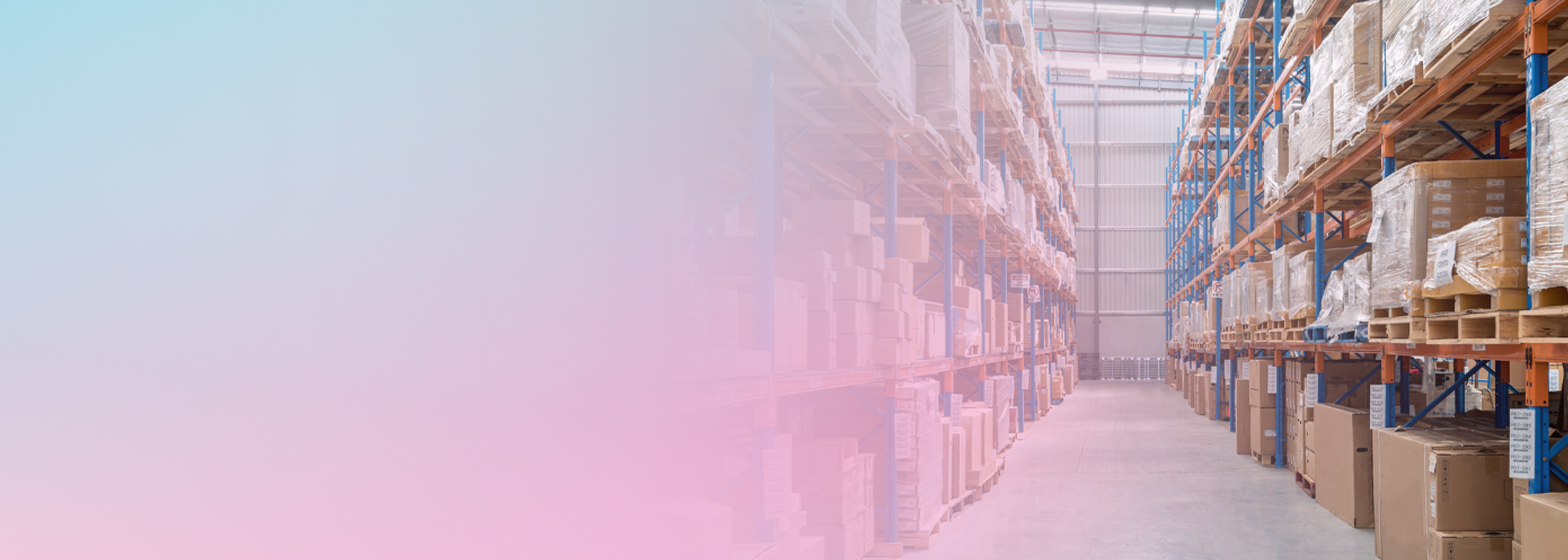 A wide-angle view of a warehouse interior with tall shelves stacked with inventory boxes and pallets, illustrating supply chain resource and inventory management.