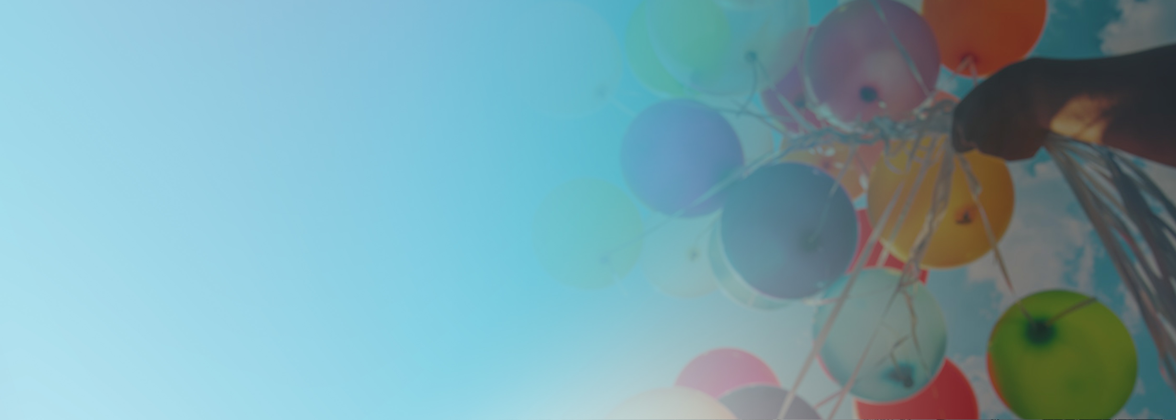 A hand holds a bunch of colorful balloons against a blue sky with clouds, with a blue gradient overlay on the left side.