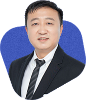 A person wearing a black suit, white shirt, and striped tie, set against a blue background.