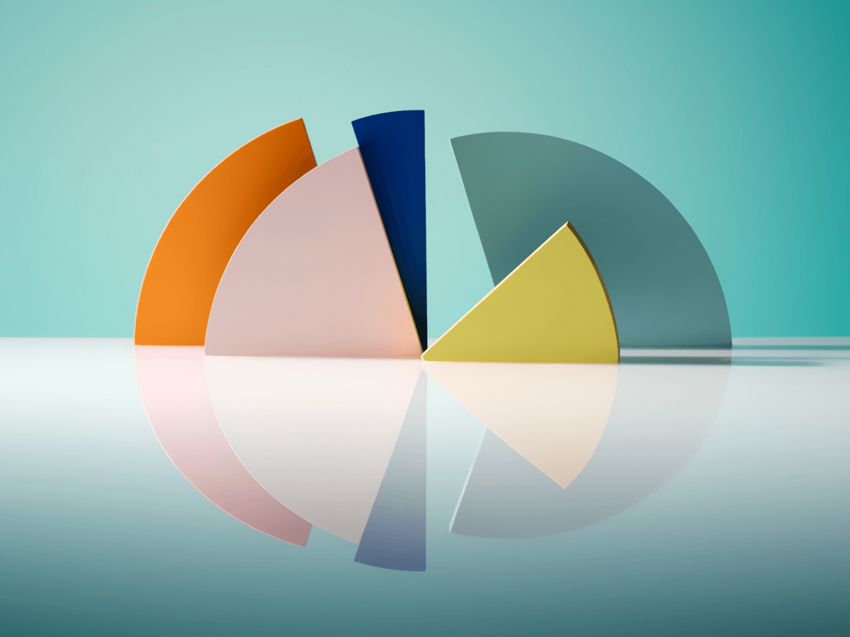 An abstract image featuring colorful 3D pie chart segments in various colors, arranged on a reflective surface with a gradient blue background.