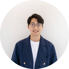 Portrait of an AWS event speaker from Gamania, shown in a blue blazer and glasses, against a plain background.