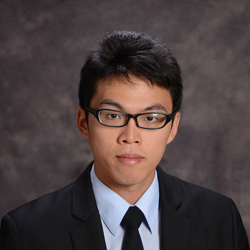 Professional portrait of a man in a suit and glasses against a gray background, used for AWS event Session 101.