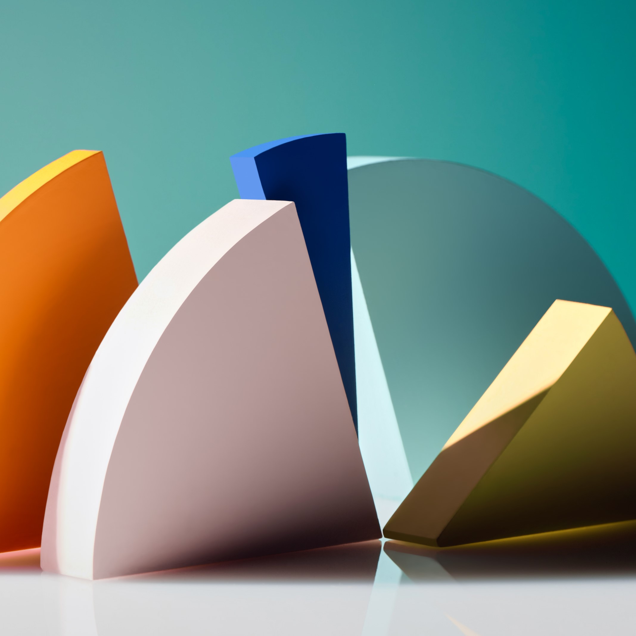 Colorful geometric shapes, including orange, pink, blue, and yellow segments, arranged against a teal background.