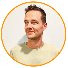 Portrait of a man with short hair wearing a light shirt in front of an orange border