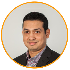 Professional headshot of a man in business attire against a neutral background, suitable for use in marketing or campaign materials.