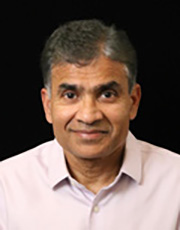 Portrait of a man in a light shirt, black background