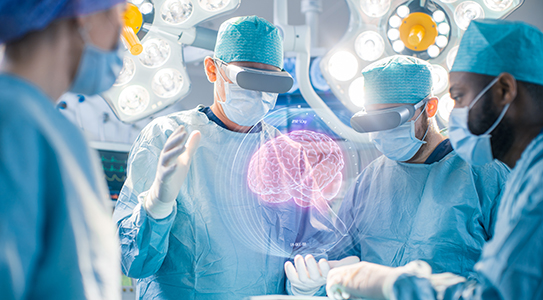 Surgeons in an operating room using augmented reality technology to visualize a 3D holographic brain.