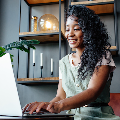 woman typing notes on laptop