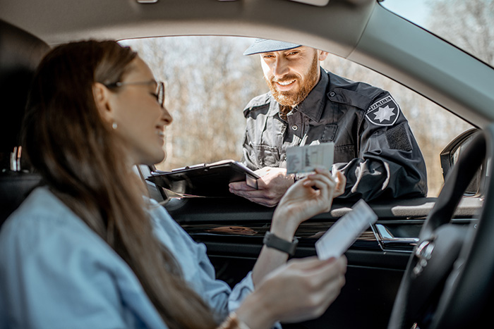 Policeman checking documents of a female driver