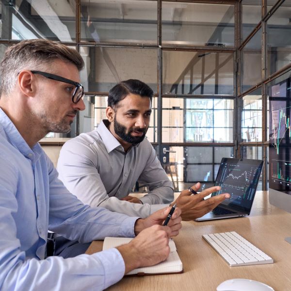 Zwei Mitarbeiter schauen sich Daten auf ihrem Computer an