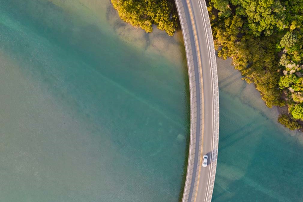 Arial shot of cars driving over a bridge