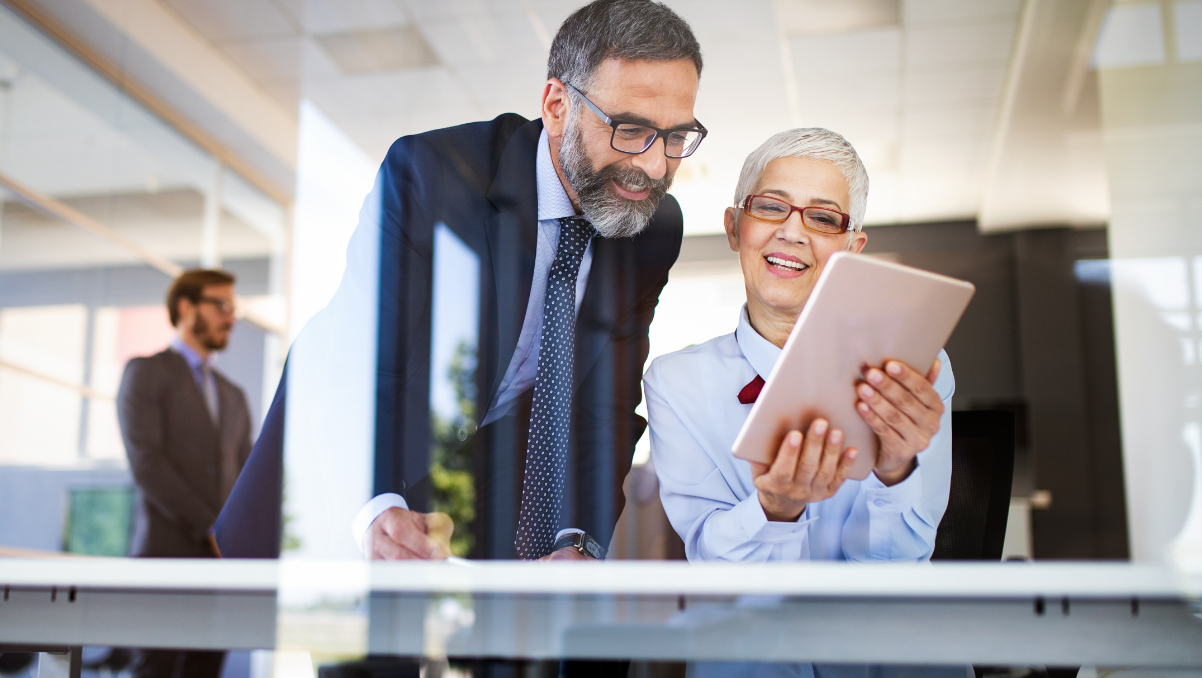 Man looking at document of a woman's shoulder