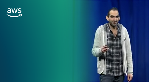 Man standing on stage giving a presentation 