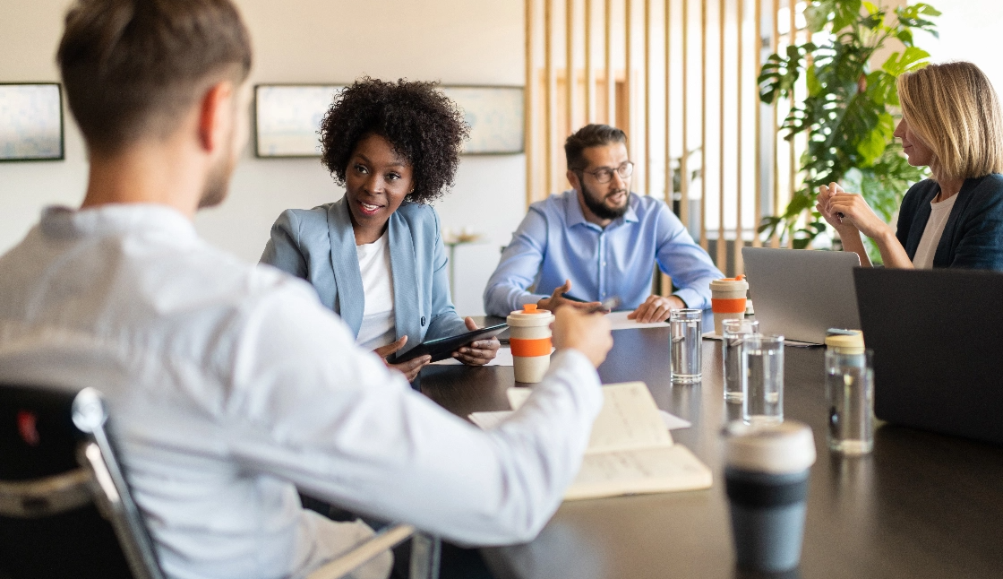 Four people sitting around a table talking