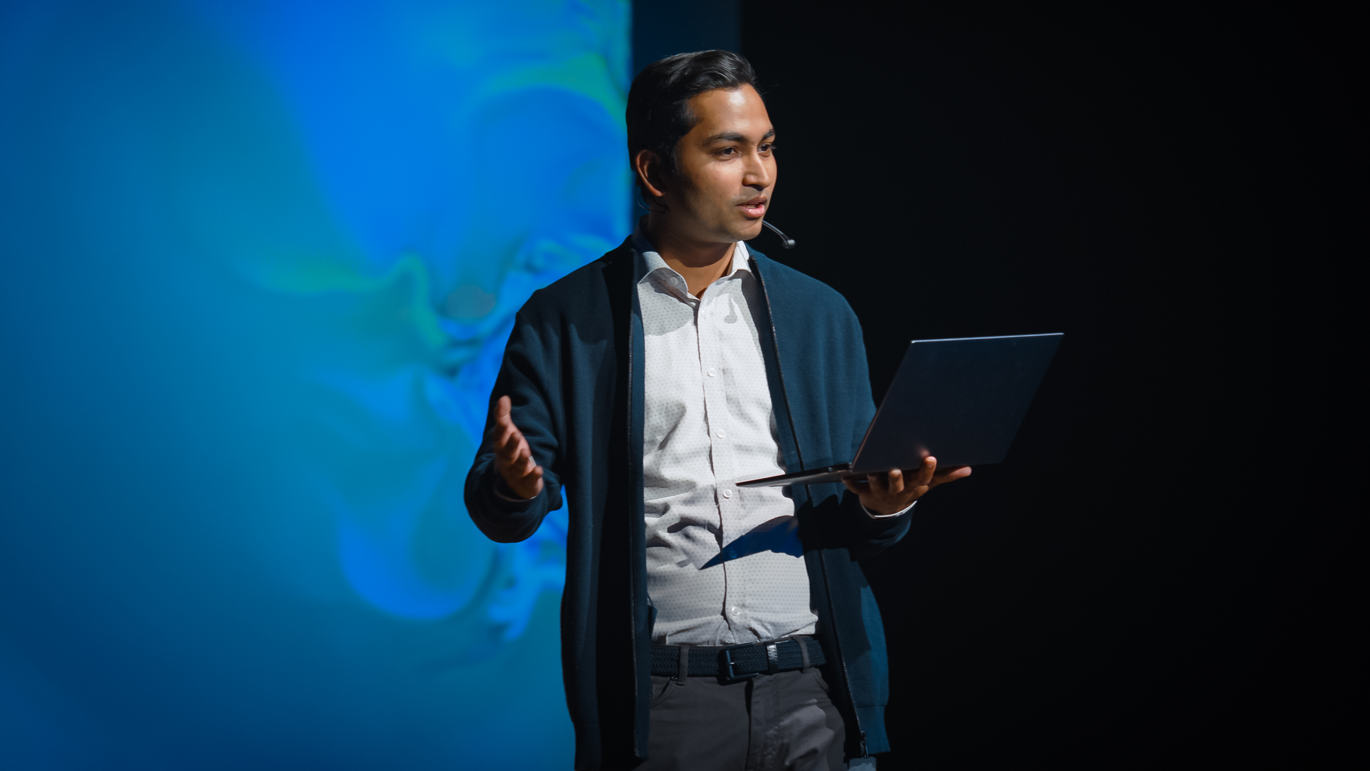 Person speaking on stage at a business conference