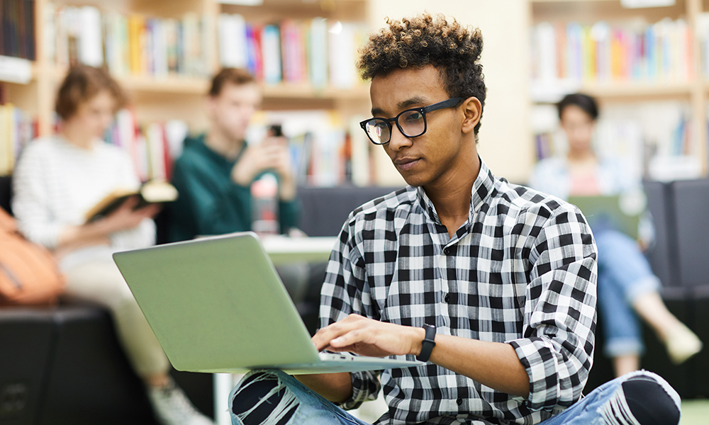 Black student boy preparing research