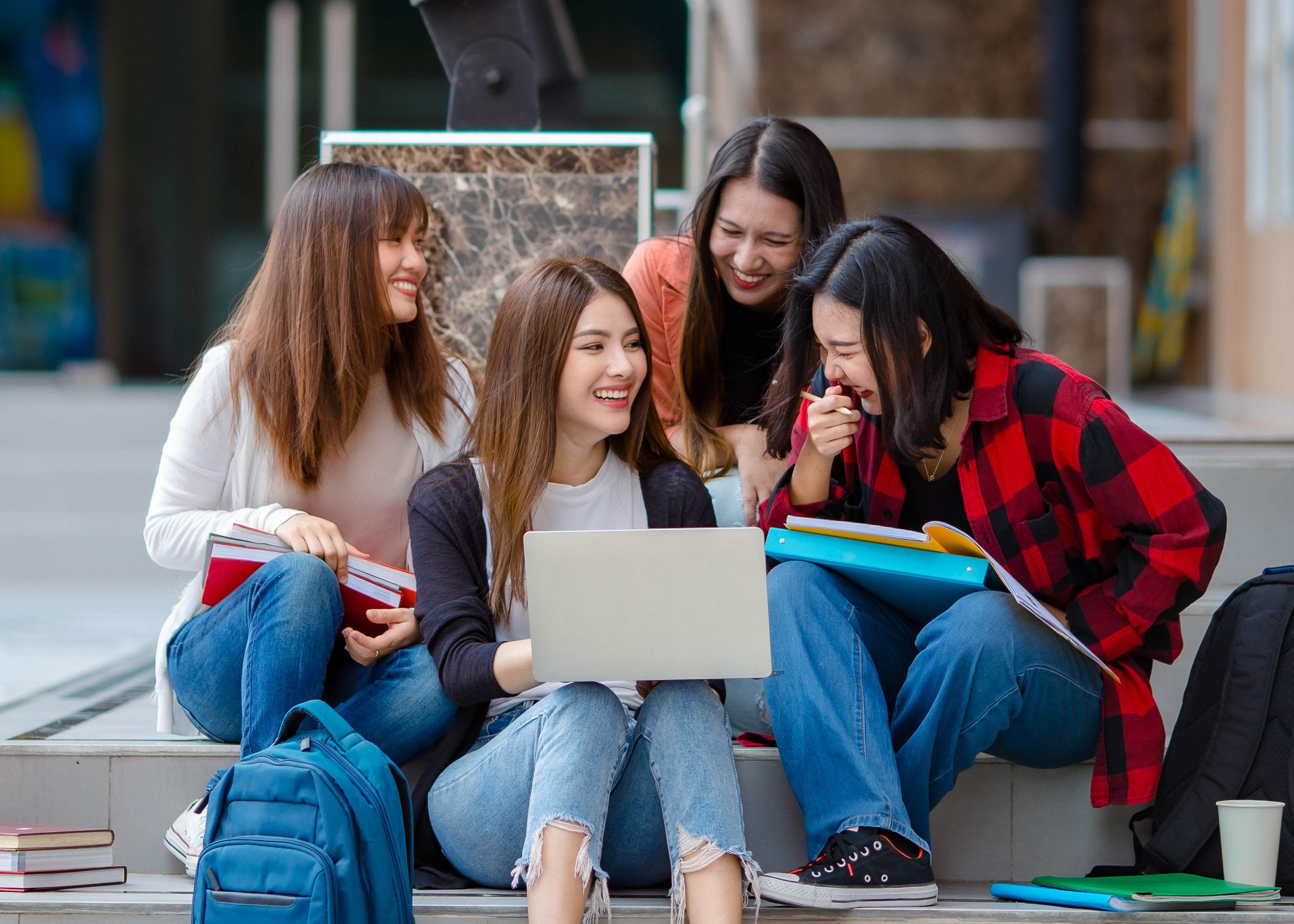 Group of students gathered around a computer 